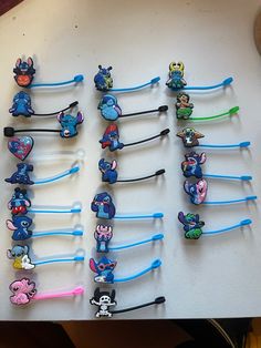 a bunch of toothbrushes that are sitting on a table with some cartoon characters attached to them