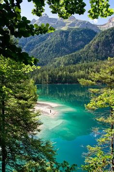 a lake surrounded by trees and mountains