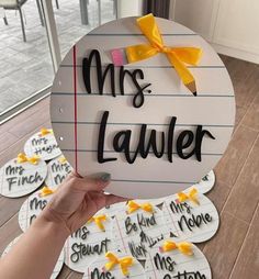 a person holding up a sign that says mrs lavrer and has been written on it