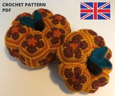 two crocheted pumpkins sitting on top of each other with an american flag in the background