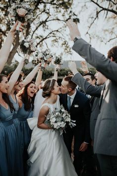 a bride and groom are surrounded by their wedding party