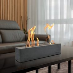 a modern fireplace with flames burning in the living room