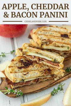 grilled apple, cheddar and bacon panini on a cutting board with apples in the background