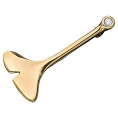 a gold colored metal object with a diamond on it's end and a white background