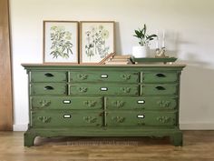 an old green dresser with two pictures on top and one plant sitting on top of it