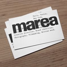 two pieces of paper with the word marea printed on them sitting on top of a wooden table