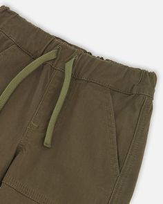 These stretch twill jogger pants are the perfect combination of comfort and style. Made from durable twill fabric, these pants have two cargo pockets for increased storage. Perfect for everyday wear or a night out. Stretch Cotton Pants With Multiple Pockets, Adjustable Waist Cotton Pants With Pockets, Cotton Khaki Cargo Pants With Elastic Waistband, Spring Cotton Cargo Joggers, Adjustable Waist Cotton Bottoms, Cotton Bottoms With Adjustable Waist, Cotton Bottoms With Side Pockets And Adjustable Waist, Cotton Utility Joggers With Tapered Leg, Utility Style Cotton Joggers With Tapered Leg