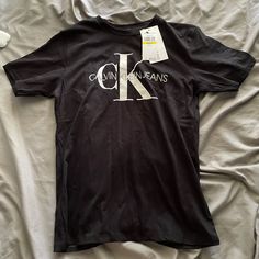 Black Calvin Klein Kids Shirt 10-12 Calvin Klein Black T-shirt For Streetwear, Calvin Klein Black Tops With Letter Print, Black Calvin Klein Crew Neck T-shirt, Calvin Klein Black Top With Letter Print, Calvin Klein Black Crew Neck T-shirt, Calvin Klein Black Streetwear T-shirt, Calvin Kelvin, Kelvin Klein, Calvin Klein Shirt