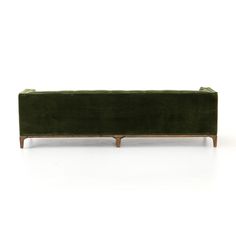 a green velvet couch with wooden legs on an isolated white background for display or montage