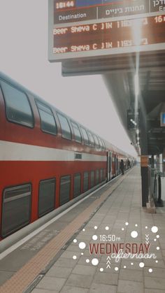 a red and white train is at the station