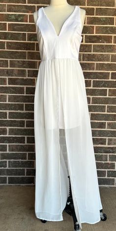 Just in time for summer, you will enjoy this short white dress made out of a thick jersey with white chiffon  long overskirt.  Manufactured by "J for Justify" this dress has a deep V neckline and a square back and closes with a 9" center back zipper.  The label lists it as a large and the body of the dress is made of 95% polyester and 5% spandex, the skirt is 100% polyester. There are some missing stitches on the back straps but everything else appears in intact.  There are not any noticeable st White Flowy Chiffon Summer Dress, White Fitted Chiffon Dress, Chiffon Stretch Beach Dress, Stretch Chiffon Beach Dress, White Sleeveless Flowy Maxi Dress, White Fitted Chiffon Party Dress, White Long Tulle Skirt Dress, White Tulle Long Skirt Dress, Sheer Stretch Maxi Dress For Summer