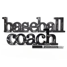 the words softball coach are made out of black plastic letters and have writing on them