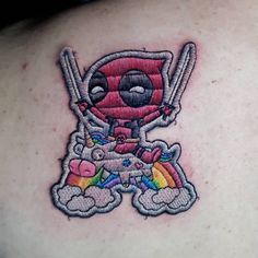 the back of a woman's shoulder with a cartoon character holding two baseball bats