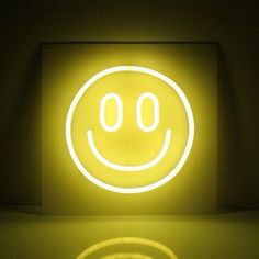 a smiley face is shown in the middle of a room with light shining on it