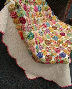 a quilted blanket is sitting on top of a chair