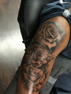 a man's arm with roses on it