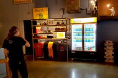 a woman standing in front of a vending machine