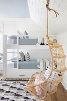 a bedroom with bunk beds and a hanging chair in the corner, along with other furniture