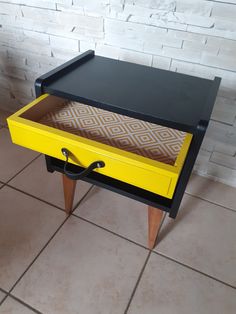 a yellow and black table with drawers on it