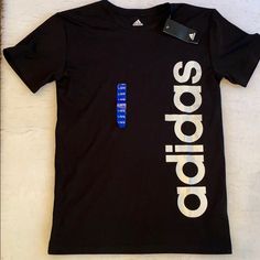 Adidas Tshirt Nwt Size Larger 14-16 Summer Black T-shirt With Name Print, Adidas Graphic Tee With Letter Print, Basic Adidas T-shirt With Graphic Print, Adidas Short Sleeve T-shirt With Letter Print, Adidas Black T-shirt With Logo, Black Adidas Logo Short Sleeve Top, Black Adidas Short Sleeve Top, Adidas Sporty Shirt With Letter Print, Sporty Adidas Shirt With Letter Print