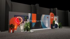 an exhibition booth with plants and lights on the wall, in front of it is a large sign that says the things together