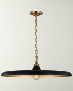 a black and gold chandelier hanging from a ceiling fixture with a light bulb on it