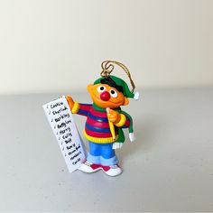 an ornament shaped like a clown holding a sign