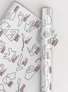 a roll of white paper with black and red designs on it