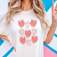 Embrace the berry trend with this artsy skater aesthetic checkered strawberry print t-shirt. Cute and casual when it's oversized for teens and trendy young moms (or trendy old moms. we don't discriminate) Printed on a TOP QUALITY Comfort Colors Tshirt Direct to Garment Printed, not a transfer 80% ringspun cotton 20% polyester Gets softer each time you wear it Sure to be your new favorite shirt! Produced and delivered in about a week with tracking provided upon shipment I accept returns/exchanges Trendy Spring Tops With Strawberry Print, Red Fruit Print Top For Spring, Summer Strawberry Print Short Sleeve Tops, Retro Spring Tops With Strawberry Print, Casual Pink Tops With Fruit Print, Retro Spring Top With Strawberry Print, Casual Pink Top With Fruit Print, Retro Strawberry Print Summer Tops, Retro Strawberry Print Tops For Summer