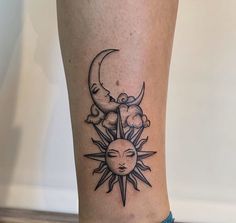 a tattoo on the leg of a woman that has a sun and moon in it