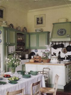 the kitchen is clean and ready for us to eat dinner in it's green cabinetry