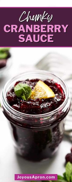 cranberry sauce in a glass jar on a table