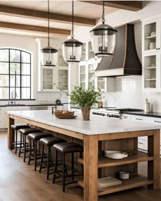 a large kitchen island with stools underneath it