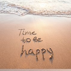 the words time to be happy written in the sand