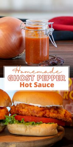 homemade ghost pepper hot sauce in a jar next to two sandwiches on a cutting board