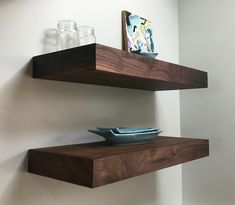 two wooden shelves with plates and glasses on them