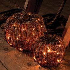 two pumpkin shaped lights sitting on top of a wooden floor