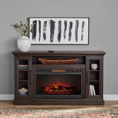 an entertainment center with a fireplace in the middle and a painting on the wall above it