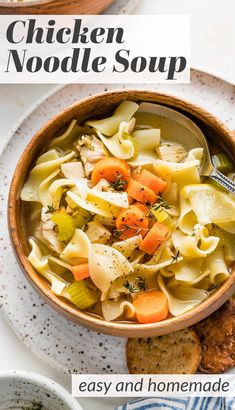 chicken noodle soup in a bowl with bread on the side