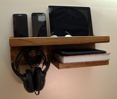 a wooden shelf with headphones and laptop on it