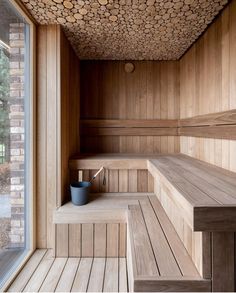 a wooden sauna with two buckets on the steps