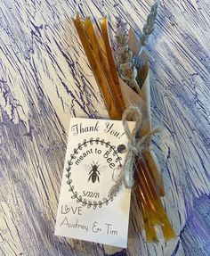 some sticks are sitting on a table with a sign that says thank you to bees