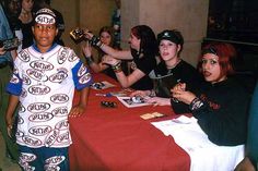 a group of young people sitting around a table