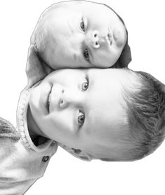 two young boys are posing for a black and white photo with their heads on each other