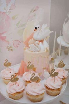 there are cupcakes with swan decorations on them