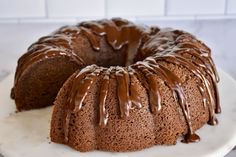 a bundt cake with chocolate icing on a white plate