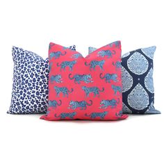 three pillows with leopards on them, one blue and the other pink in different colors