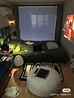 a bed room with a laptop on top of it next to a large screen tv