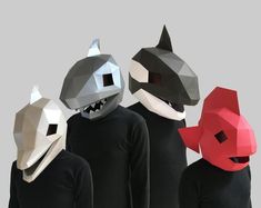 three people in black shirts with shark masks on their faces and one wearing a red mask