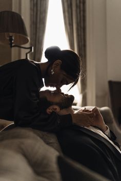 a man kissing a woman on the forehead